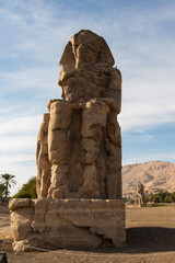 Colossi of Memnon Luxor Thebes against the background of dawn in the Egypt