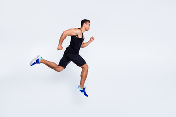 Full length body size view of his he nice attractive strong sportive muscular focused guy jumping running fast championship isolated over light gray pastel color background
