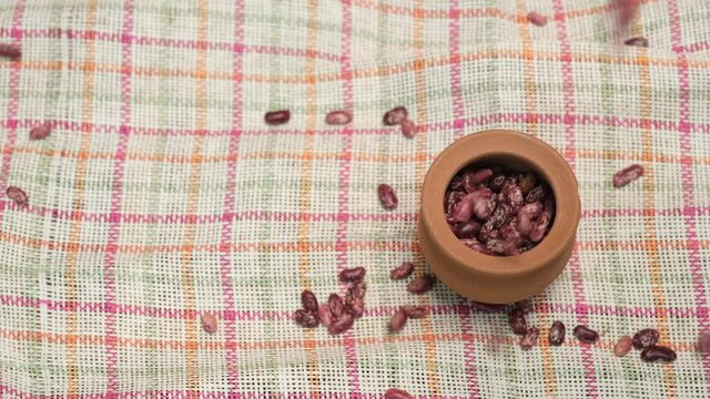 Dried Red beans in a faience pot. 4k video shot.