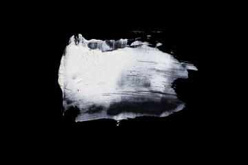 Brushstroke with a thick white paint, isolated on a black background.