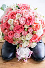 wedding bouquet on men's shoes
