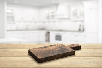 wooden table top with cutting board in front of blurred kitchen - 3D Illustration