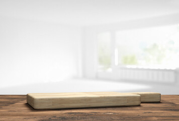 Fototapeta na wymiar wooden table top with cutting board in front of blurred kitchen - 3D Illustration
