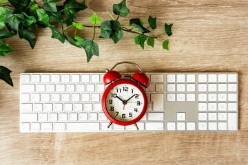 Computer and alarm clock. Work hours, working hours, telework, business, job changes, etc....