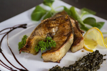 the chef chopped fresh sturgeon and grilled it
