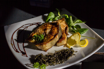 the chef chopped fresh sturgeon and grilled it