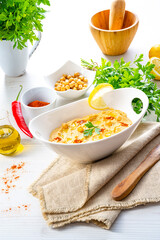 hummus paste with lemon and chilli on white background