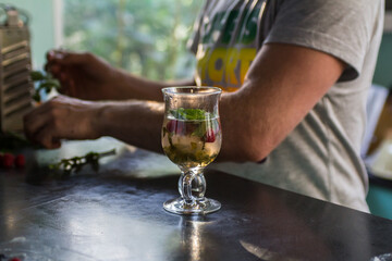 refreshing berry cocktail with mint, lemon, lime and raspberries in a beautiful glass with a green straw