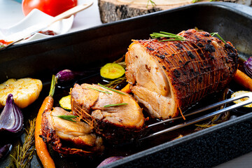 Lecere roll roast with vegetables and herbs.