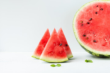 Slices of sliced ripe, juicy, sweet watermelon on a light background front view. The concept of...