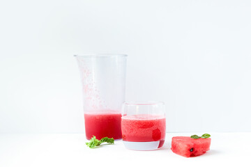 Fototapeta na wymiar Watermelon smoothie in clear glass glasses with lemon slices on a light background. The concept of light, summer, healthy food.