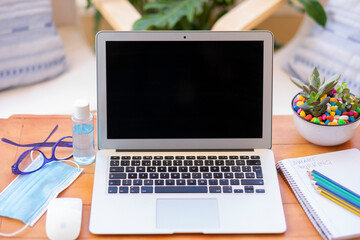 Fototapeta premium The new normal due to coronavirus, work from home using internet connection - with face mask and disinfectant