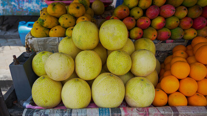 Grapefruit, orange, mangoes fruit for sale in a fruit shop