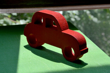 red toy car on the green grass