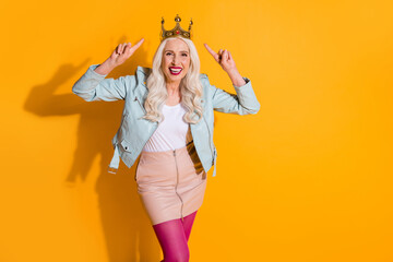 Portrait of her she nice-looking attractive lovely charming lovely cheerful cheery gray-haired woman wearing showing crown isolated over bright vivid shine vibrant yellow color background