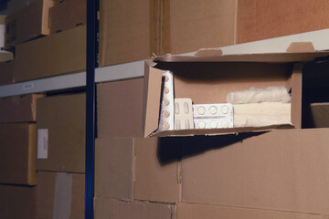 Theft of pills in a warehouse during a lockdown. Empty warehouse with opened boxes of medicines