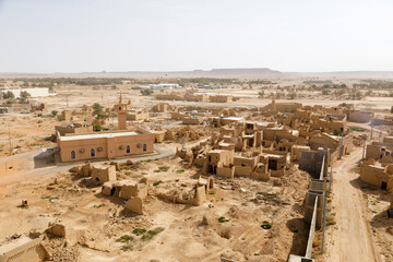 View of the small village Raghba with the abandoned mud houses in the middle of the desert in Saudi Arabia