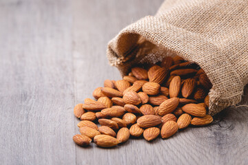 almonds in the bag on wooden table