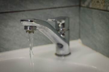 water flowing from faucet in bathroom