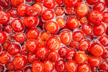 Homemade cherry jam. Cooking sweet merry jam. Side view. Closeup