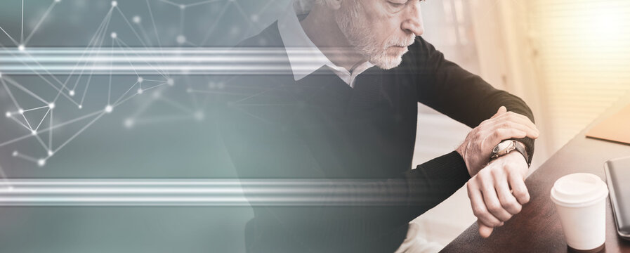 Businessman checking time on his wrist watch; panoramic banner