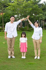 Happy family  smiling together on the grass