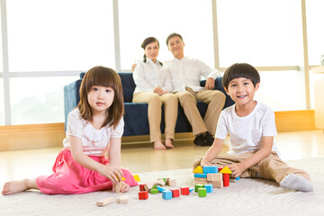 Happy family building blocks at home