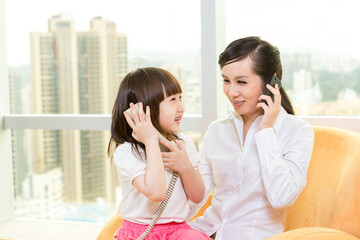 Mother and daughter playing together at home