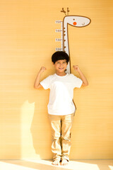 Little boy measuring his height at home