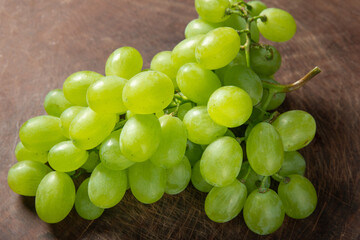 bunch of grapes on a wooden table