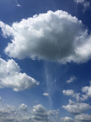 Picturesque Cumulus clouds against the blue sky. Photo in the style of a painting with small strokes.