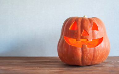Halloween pumpkin lantern close-up on a gray background. Copy space