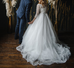 Obraz na płótnie Canvas young slender bride in a long white elegant wedding dress. honeymoon ceremony