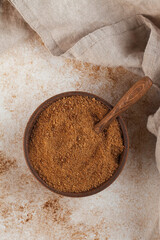 Coconut sugar in a wooden bowl with a palm leaf. Minimalism. The concept of healthy eating.