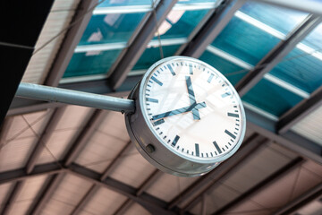 Clock tells the time on the train in the train station
