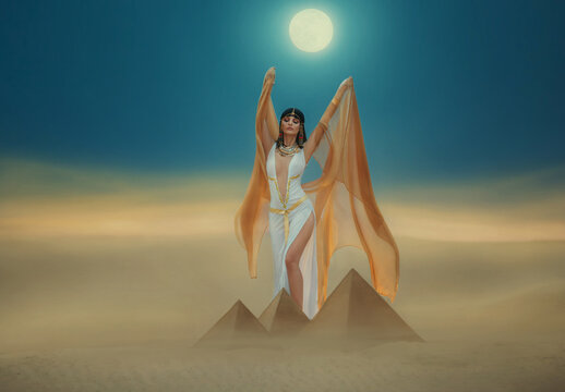 Artwork Fantasy egyptian beauty goddess Cleopatra raises hands to blue night sky, backdrop pyramid yellow sand dune bright moon light. Orange golden cape white sexy dress. Black hair queen Nefertiti