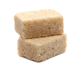 Brown cane sugar cubes, two pieces isolated on white background