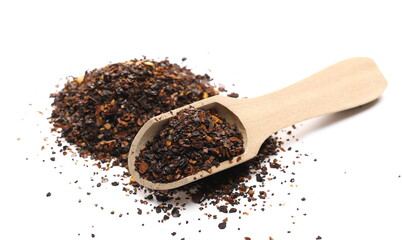 Aromatic spicy chili pepper flakes, dry ancho chili pile with wooden spoon isolated on white background