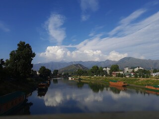 River with crystal clear water with mountains in background