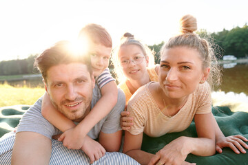 Portrait of family while having holiday by the lake