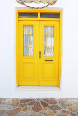 traditional wooden yellow door at Koufonisia islands Cyclades Greece
