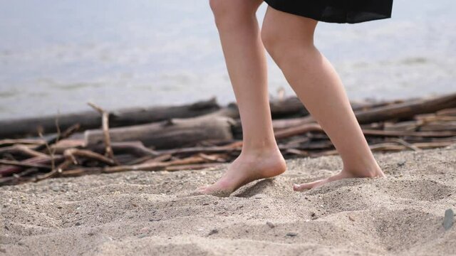 Happy Blond Beautiful Girl Relaxing On Vacation Beach. close up of her feet