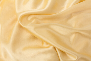 Smooth elegant golden silk or satin luxury cloth texture can use as wedding background. Luxurious background design.  Retro style