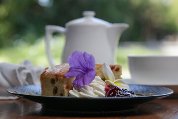 Raisin bread decorated with edible flowers served on the wooden table