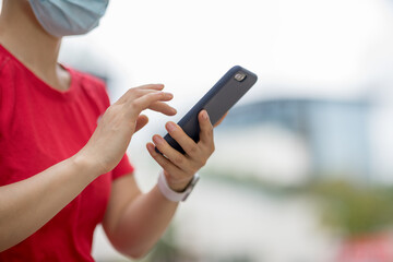 Asian woman using smartphone in modern city