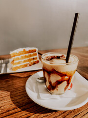 Capuccino and frape coffees with a carrot cake 