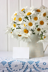 bouquet of daisies and an empty card. mockup, scene creator.