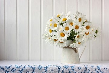 Bouquet of garden daisies on the table