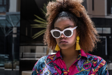 Trendy ethnic woman in stylish sunglasses