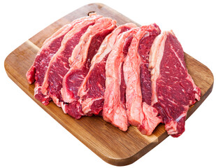 Obraz premium Preparation of raw beef fillet on wooden cutting board. Isolated over white background
